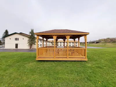 a wooden gazebo in the middle of a field at Super 8 by Wyndham Amsterdam in Amsterdam