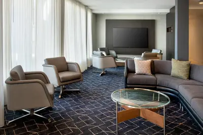 a living room with couches and a flat screen tv at Courtyard by Marriott New Haven Wallingford in Wallingford