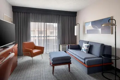 a living room with a couch and a chair at Courtyard by Marriott New Haven Wallingford in Wallingford