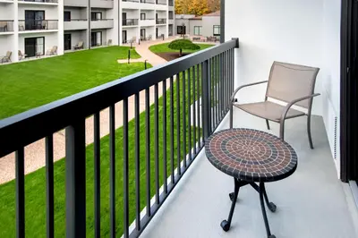 a chair and a table on the balcony of a building at Courtyard by Marriott New Haven Wallingford in Wallingford