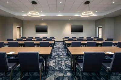 a conference room with tables and chairs and screens at Courtyard by Marriott New Haven Wallingford in Wallingford