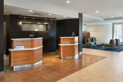 a lobby with a waiting area with chairs and a table at Courtyard by Marriott New Haven Wallingford in Wallingford
