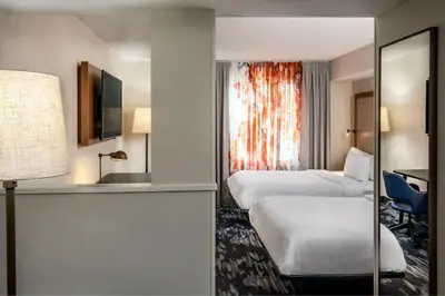 a hotel room with two beds and a window at Fairfield Inn & Suites by Marriott Saratoga Malta in Malta