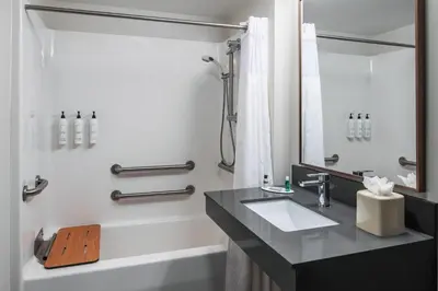a bathroom with a sink and a bath tub at Fairfield Inn & Suites by Marriott Saratoga Malta in Malta