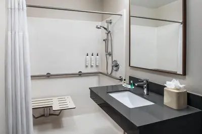 a bathroom with a sink and a mirror at Fairfield Inn & Suites by Marriott Saratoga Malta in Malta
