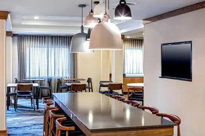 a conference room with tables and chairs and a tv at Fairfield Inn & Suites by Marriott Saratoga Malta in Malta