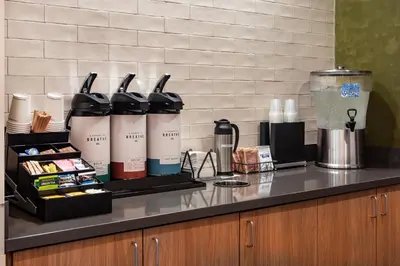 a counter top with a group of bottles on it at Fairfield Inn & Suites by Marriott Saratoga Malta in Malta