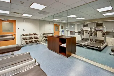 a waiting room with a bunch of equipment in it at Fairfield Inn & Suites by Marriott Saratoga Malta in Malta