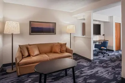 a living room with a couch and a table at Fairfield Inn & Suites by Marriott Saratoga Malta in Malta