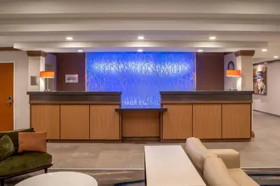 a large screen in a lobby with a waiting room at Fairfield Inn & Suites by Marriott Saratoga Malta in Malta