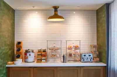 a kitchen with a counter with bakery items on it at Fairfield Inn & Suites by Marriott Albany Airport in Albany