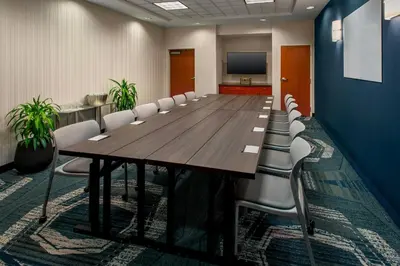 a large conference room with a long table and chairs at SpringHill Suites by Marriott Albany Latham-Colonie in Albany