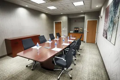 a conference room with a long table and chairs at SpringHill Suites by Marriott Albany Latham-Colonie in Albany