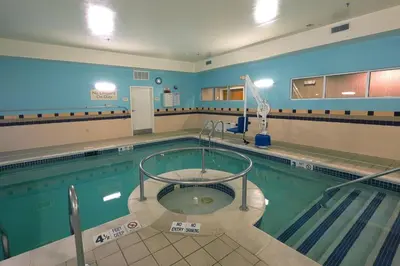 an indoor swimming pool with a pooliteratoriteratorython at SpringHill Suites by Marriott Albany Latham-Colonie in Albany