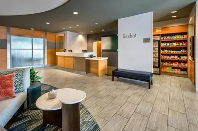 a waiting area of a pharmacy with a counter and tables at SpringHill Suites by Marriott Albany Latham-Colonie in Albany