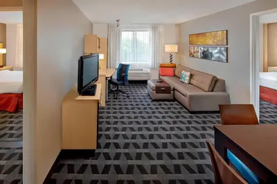 a hotel room with a couch and a living room at TownePlace Suites by Marriott Albany Downtown/Medical Center in Albany
