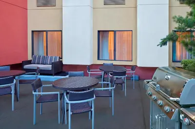 a restaurant with tables and chairs and a grill at TownePlace Suites by Marriott Albany Downtown/Medical Center in Albany