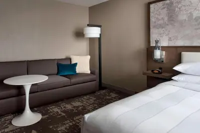 a hotel room with a bed and a couch at Marriott Albany in Albany