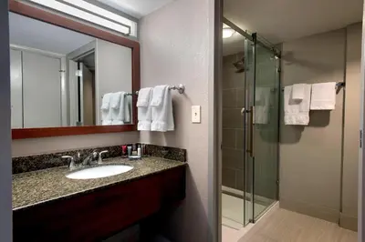 a bathroom with a sink and a shower at Marriott Albany in Albany