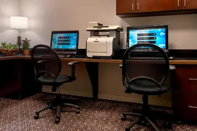 an office with two desks with two chairs and a printer at Marriott Albany in Albany