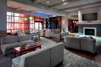 a large living room with couches and a fireplace at Marriott Albany in Albany