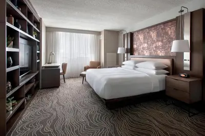 a hotel room with a bed and a television at Marriott Albany in Albany