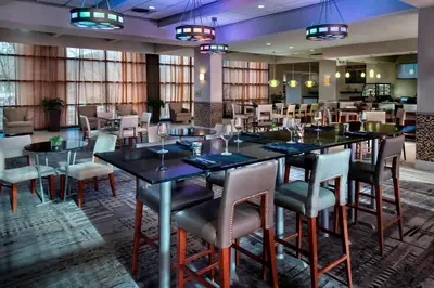 a large dining room with tables and chairs at Marriott Albany in Albany
