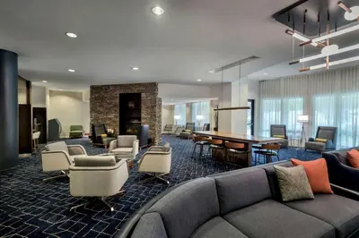 a lobby with a couch and a table and chairs at Courtyard by Marriott Paramus in Paramus