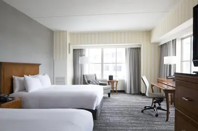 a hotel room with two beds and a desk at Hartford Marriott Downtown in Hartford