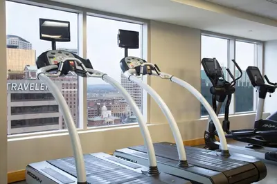 a gym with tread machines in a room with windows at Hartford Marriott Downtown in Hartford