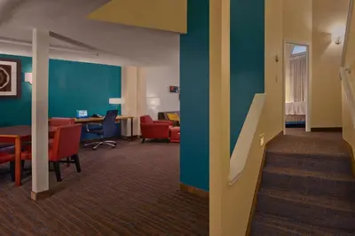 a living room with a table and chairs in a room at Residence Inn by Marriott Hartford Downtown in Hartford