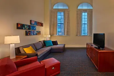 a living room with a couch and a tv at Residence Inn by Marriott Hartford Downtown in Hartford