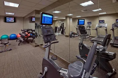 a gym with several tread machines and a mirror at Residence Inn by Marriott Hartford Downtown in Hartford