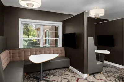a waiting room with a table and a window at Residence Inn East Rutherford Meadowlands in East Rutherford