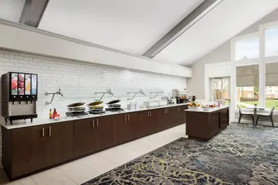 a large kitchen with brown cabinets and a counter top at Residence Inn by Marriott Saddle River in Saddle River