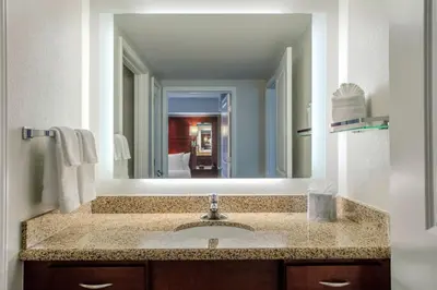 a bathroom with a sink and a large mirror at Residence Inn by Marriott Yonkers Westchester County in Yonkers