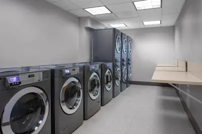 a row of washing machines in a laundry room at Residence Inn by Marriott Yonkers Westchester County in Yonkers