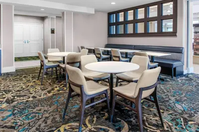 a group of tables and chairs in a waiting room at Residence Inn by Marriott Yonkers Westchester County in Yonkers