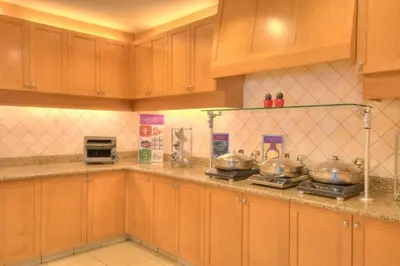 a kitchen with wooden cabinets and pots on the counter at Residence Inn by Marriott Yonkers Westchester County in Yonkers