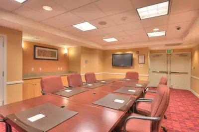 a conference room with a large wooden table and chairs at Residence Inn by Marriott Yonkers Westchester County in Yonkers