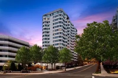 a tall white building on a city street with trees at Residence Inn White Plains Westchester County in White Plains