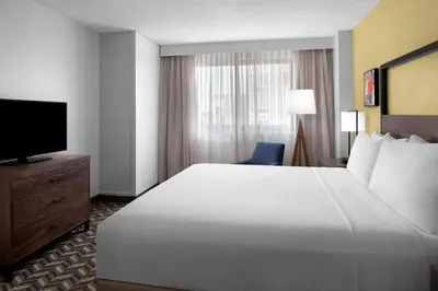 a hotel room with a large bed and a television at Residence Inn White Plains Westchester County in White Plains