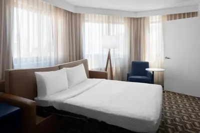 a hotel room with a bed and a chair at Residence Inn White Plains Westchester County in White Plains