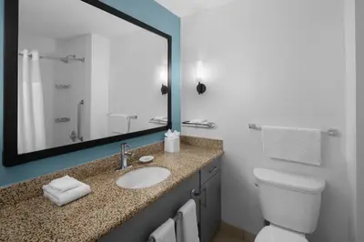 a bathroom with a sink and a toilet and a mirror at Residence Inn White Plains Westchester County in White Plains
