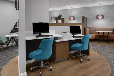 an office with two blue chairs and a desk with a computer at Residence Inn White Plains Westchester County in White Plains