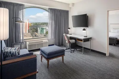 a hotel room with a bed and a desk with a computer at Courtyard by Marriott Stamford Downtown in Stamford