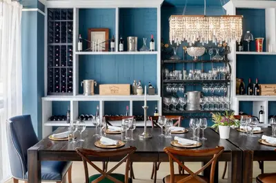 a dining room with blue walls and a table with chairs at Courtyard by Marriott Stamford Downtown in Stamford