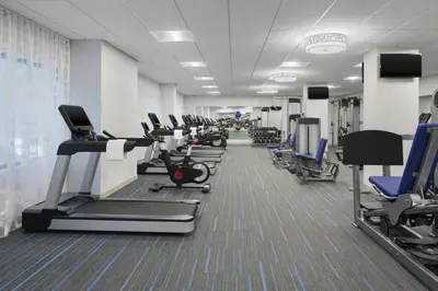 a gym with a row of treadms and machines at Courtyard by Marriott Stamford Downtown in Stamford