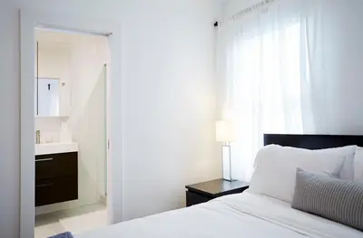 a bedroom with a bed and a sink and a mirror at Station Inn Pawling in Pawling