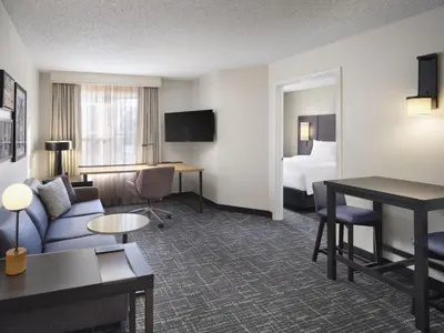 a hotel room with a couch and a bed at Residence Inn by Marriott Albany East Greenbush/Tech Valley in East Greenbush